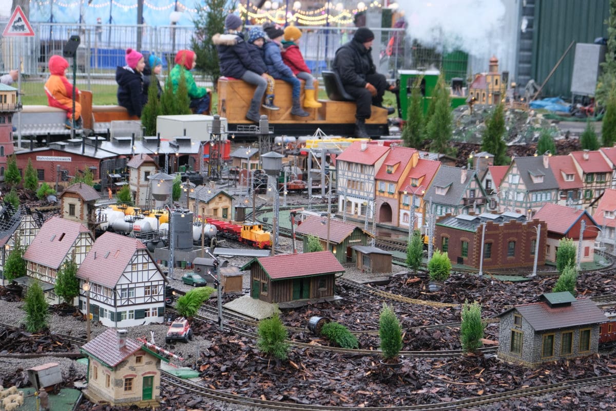 Kids riding the model train railway at Christmas market