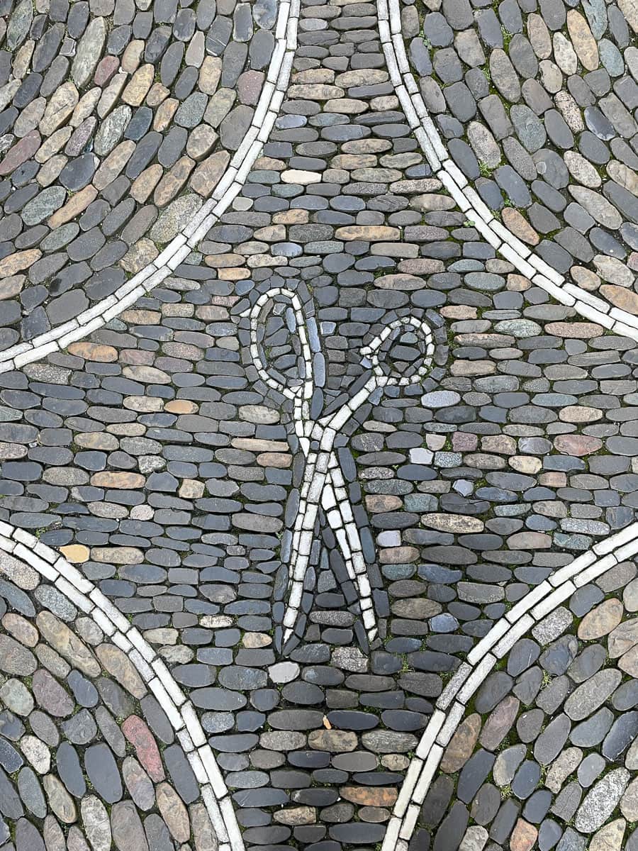 Barber shop scissors make of stone in sidewalk